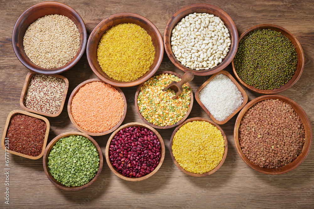 bowls of legumes, lentils, chickpeas, rice and beans on wooden background bowls of legumes, lentils, chickpeas, rice and beans on wooden background