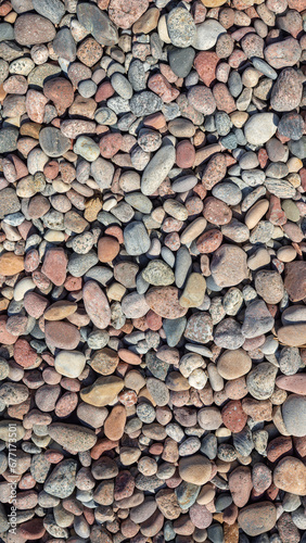 Colorful stones vertical background. Multi color beach stones small stones wallpaper