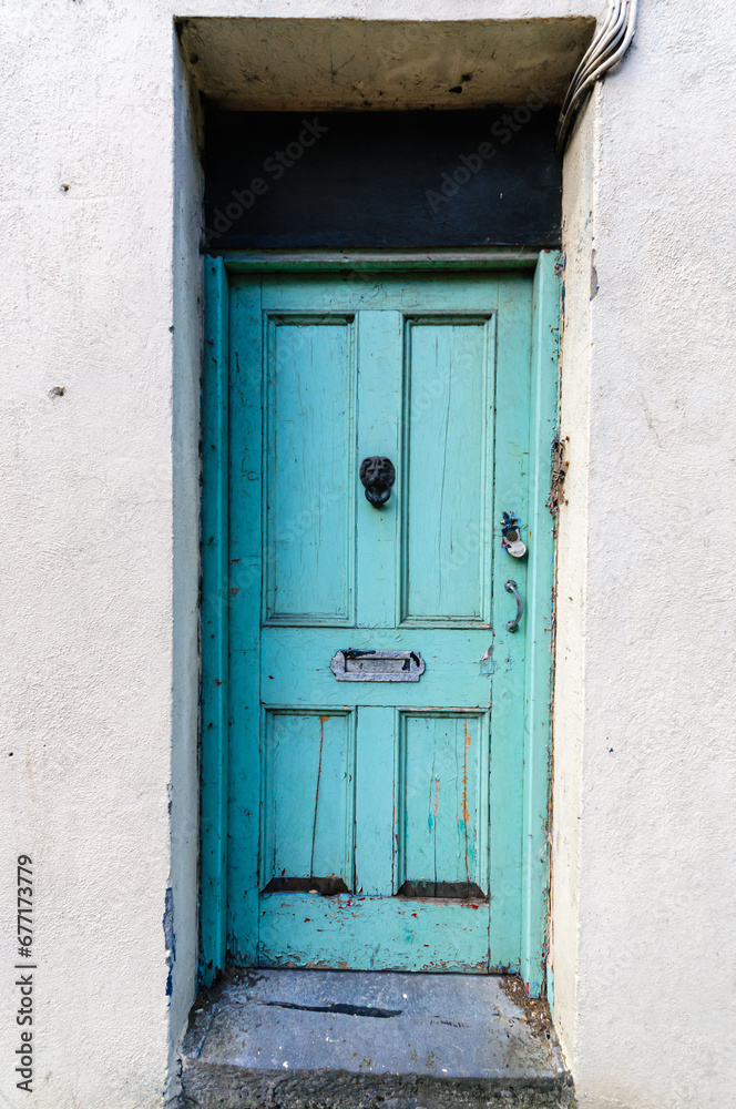 Pale blue wooden door on an abandoned house. Pale blue wooden door on an abandoned house.