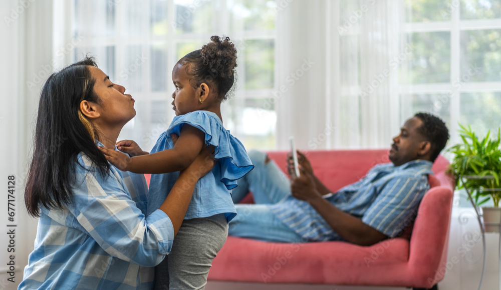 Portrait of enjoy happy love black family, play, having fun, daughter, parenthood, care, african american father and mother with little african girl child smiling moments good time at home Portrait of enjoy happy love black family, play, having fun, daughter, parenthood, care, african american father and mother with little african girl child smiling moments good time at home