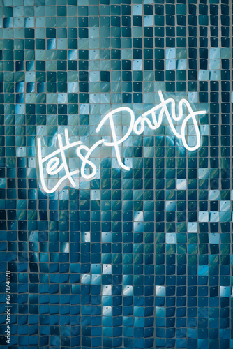 Photo zone decor with balloons of silver and blue collars , neons text birthday party let's party