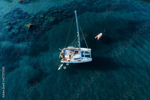 Amazing top view of Catamaran anchored in blue sea in summer. Travel background. Cruise vacation. © Paopano