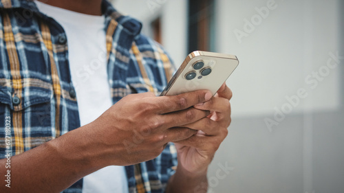 Close-up of the hands of young unrecognizable man holding mobile phone