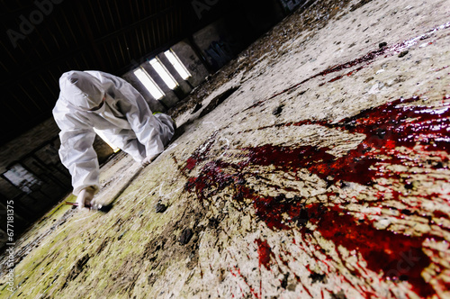 Принти на полотні Scene of Crime Officer (SOCO) examines an area around some blood on a floor