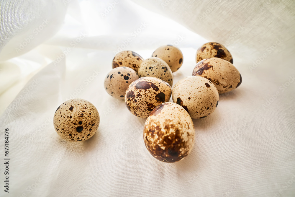 Quail eggs on a white linen towel close-up. Quail eggs on a white linen towel close-up.