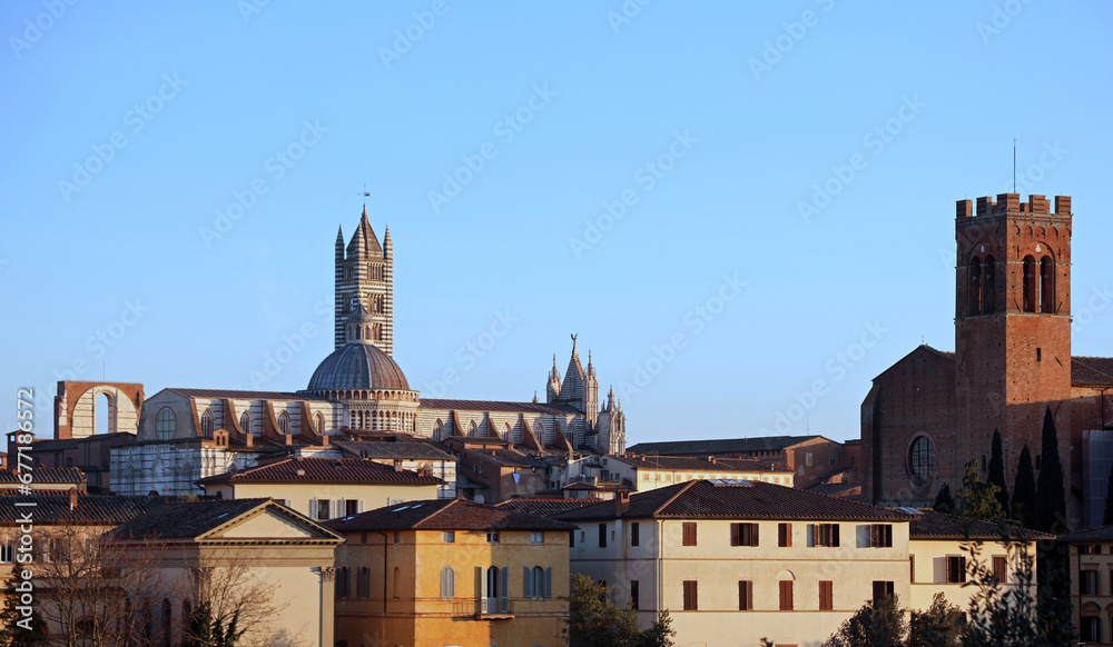 Bell Tower and Cathedral of Siena in  Italy at sunset