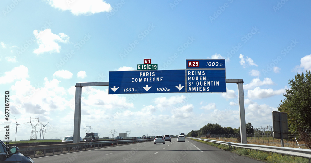 Φωτογραφία large road sign with French locations to go to the city of Paris or other places