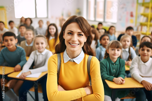 Female portrait of young teacher in class looking at camera with students in the background, back to school.