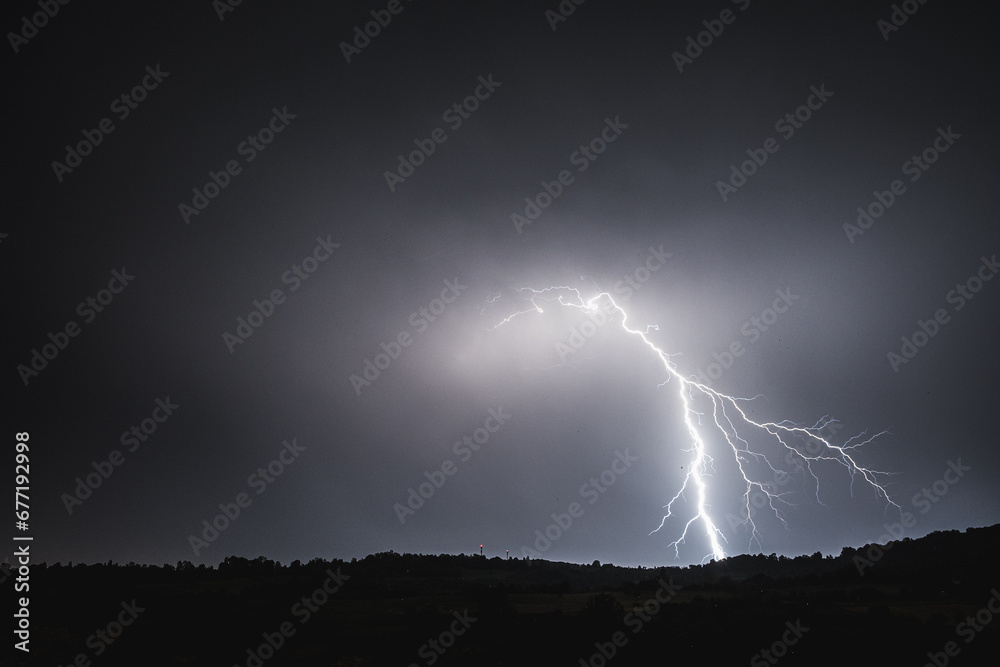 Lightning bolt on the dark cloudy sky Lightning bolt on the dark cloudy sky