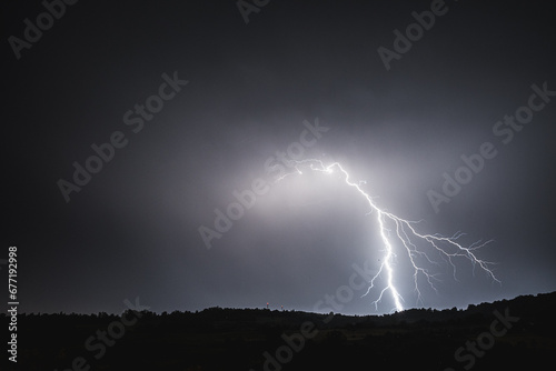 Lightning bolt on the dark cloudy sky