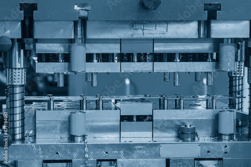 The metalworking process by progressive die in the light blue scene.