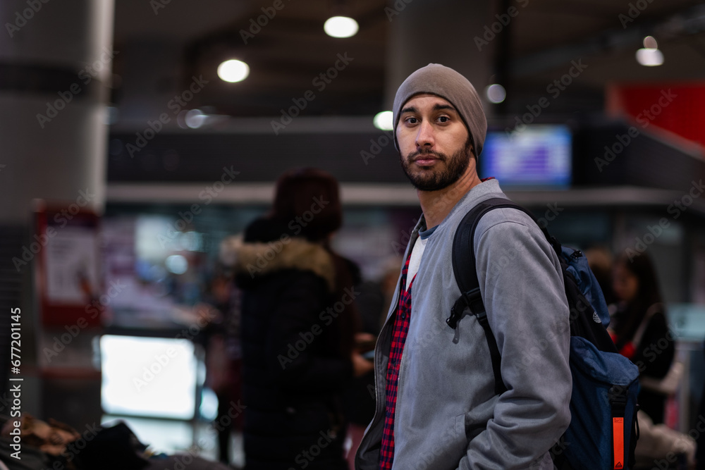 Tourist in train station, urban casual style, half-body portrait, seemingly disoriented.