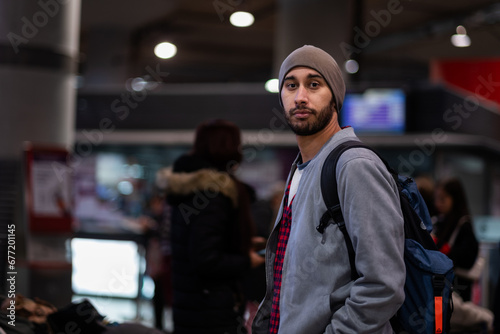 Tourist in train station, urban casual style, half-body portrait, seemingly disoriented.