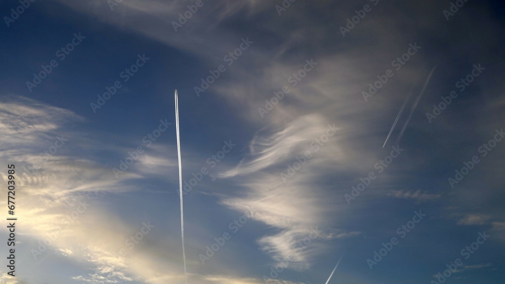 Blue sky with clouds and an airplane Blue sky with clouds and an airplane