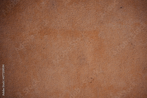 A close-up of a textured brown surface with a sleek black border