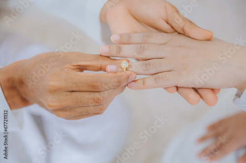 Wear a wedding ring on the ring finger of the left hand.