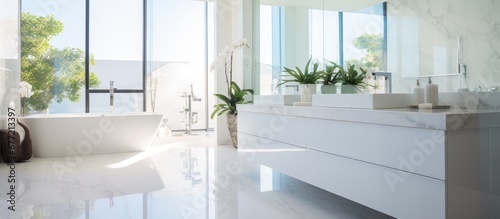 The bathroom in their beautiful modern house showcased a luxurious white interior design with stunning glass windows that allowed natural light to flood the room The sleek furniture and exq