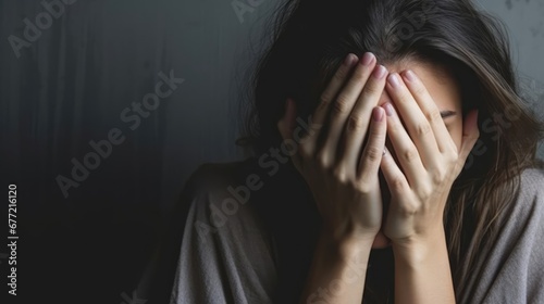 Exhausted mother covering her face in distress With copyspace for text  photo