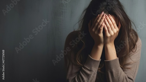 Exhausted mother covering her face in distress With copyspace for text  photo