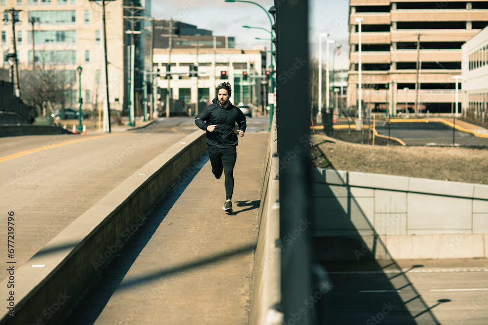 Active young man runner jogging on bridge Active young man runner jogging on bridge