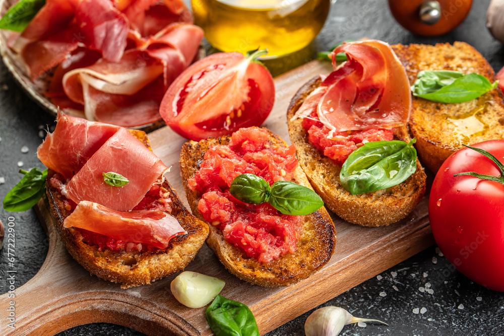 typical Spanish breakfast Jamon Iberico ham and tomatoes, olive oil ...