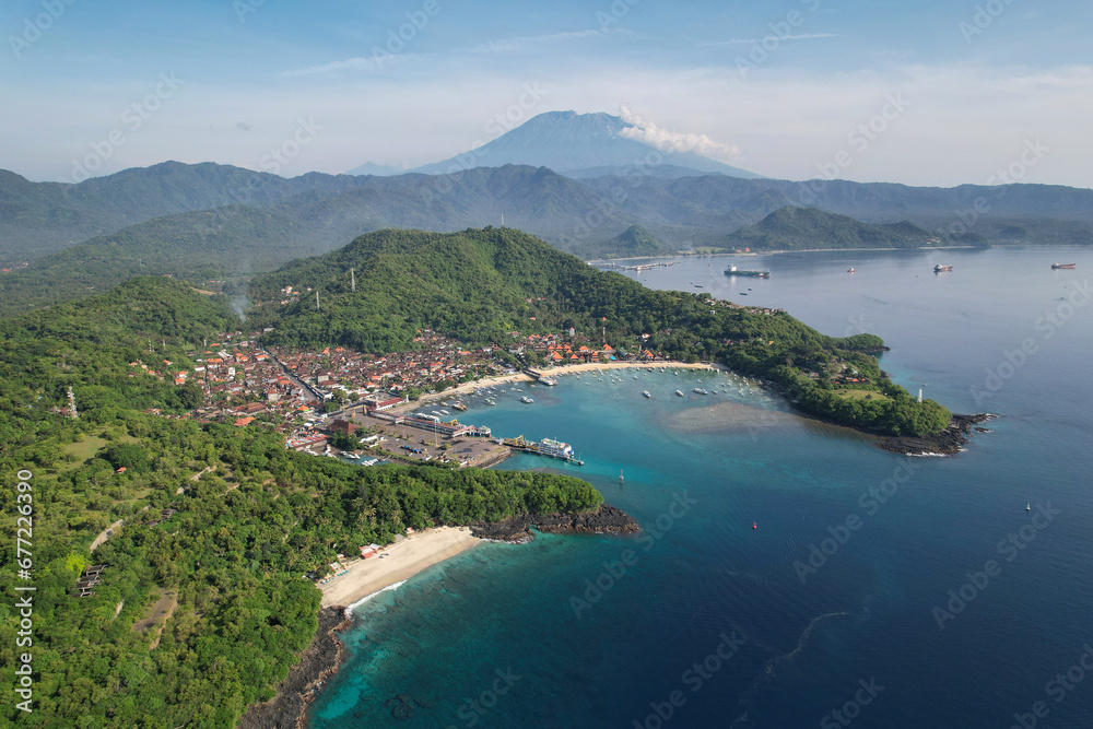 Drone view of Bias Tugel Beach, Padangbai bay and Mount Agung on sunny day. Manggis, Bali, Indonesia.