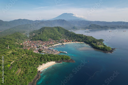 Drone view of Bias Tugel Beach, Padangbai bay and Mount Agung on sunny day. Manggis, Bali, Indonesia.