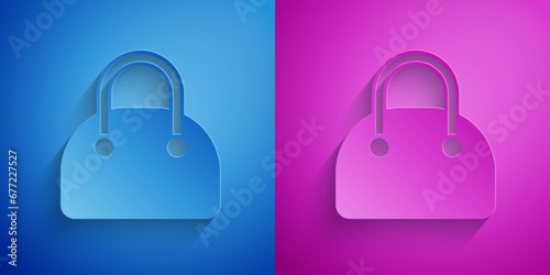 Paper cut Handbag icon isolated on blue and purple background. Female handbag sign. Glamour casual baggage symbol. Paper art style. Vector