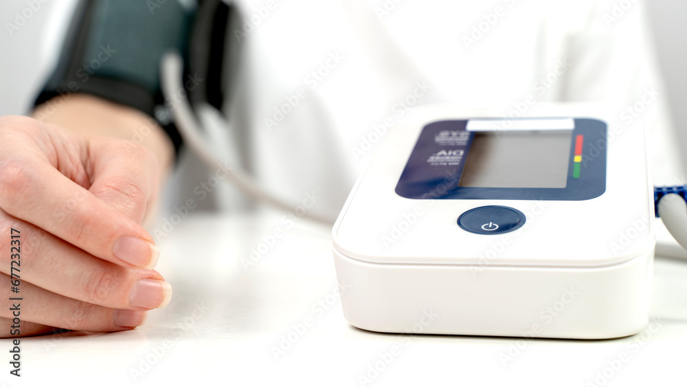 the girl measures blood pressure with a tonometer the girl measures blood pressure with a tonometer