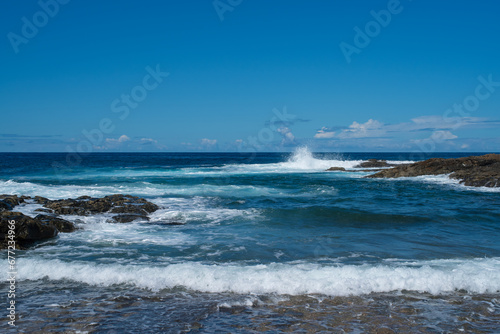Beautiful landscape with deep blue water. Powerful waves crash against black volcanic rocks on the coast of ´Aguas Verdes, Fuerteventura island.