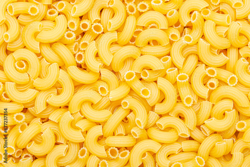 Uncooked macaroni elbow shape pasta texture background Uncooked macaroni elbow shape pasta texture background
