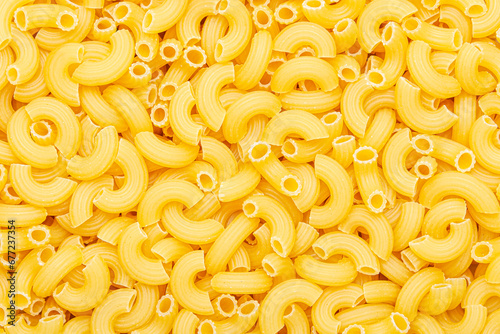 Uncooked macaroni elbow shape pasta texture background