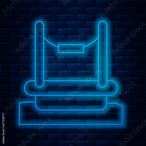 Glowing neon line Bungee trampoline attraction with metal ladder icon isolated on brick wall background. Vector