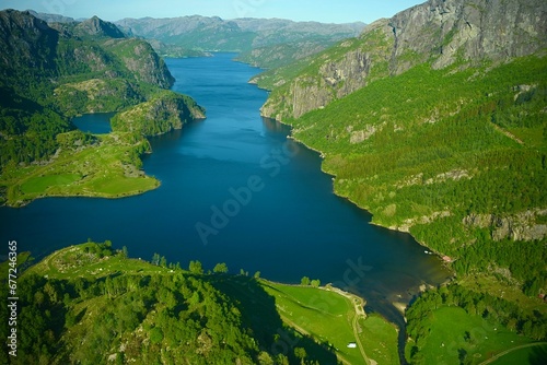 Bird's eye view of fjord surrounded by green vegetation in Norway