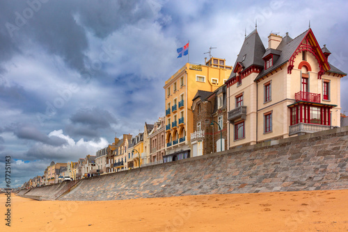 High stone embankment and beach at low tide, in beautiful Saint-Malo, Brittany, France