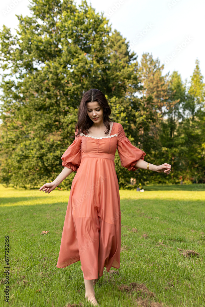 Portrait of a beautiful brunette girl in dress walking in the park, tree background. Summer time.
Portrait of a beautiful brunette girl in dress walking in the park, tree background. Summer time.