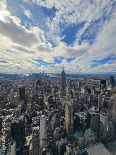 Aerial view of the Manhattan Skyline with a cloudy blue sky