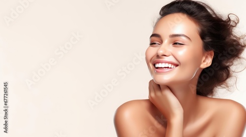 Woman smiling while touching her flawless glowy skin with copy space for your advertisement skincare