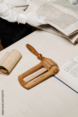 Jewish grogger noisemaker and Hebrew bible for praying and celebration Purim festival. Purim Jewish religious holiday of Israel. photo