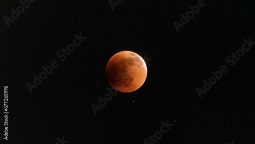 Scenic shot of the total eclipse of the moon in space on a black background © Wirestock