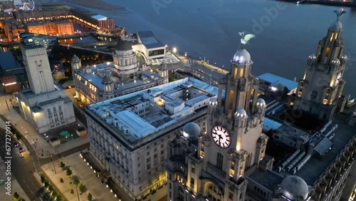 Three Graces buildings in Liverpool at night, England, UK (aerial view)