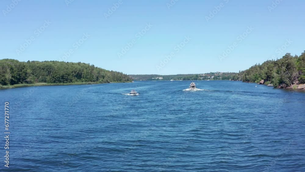 Boats in archipelago Stockholm Sweden cruising warm summer day blue sea water