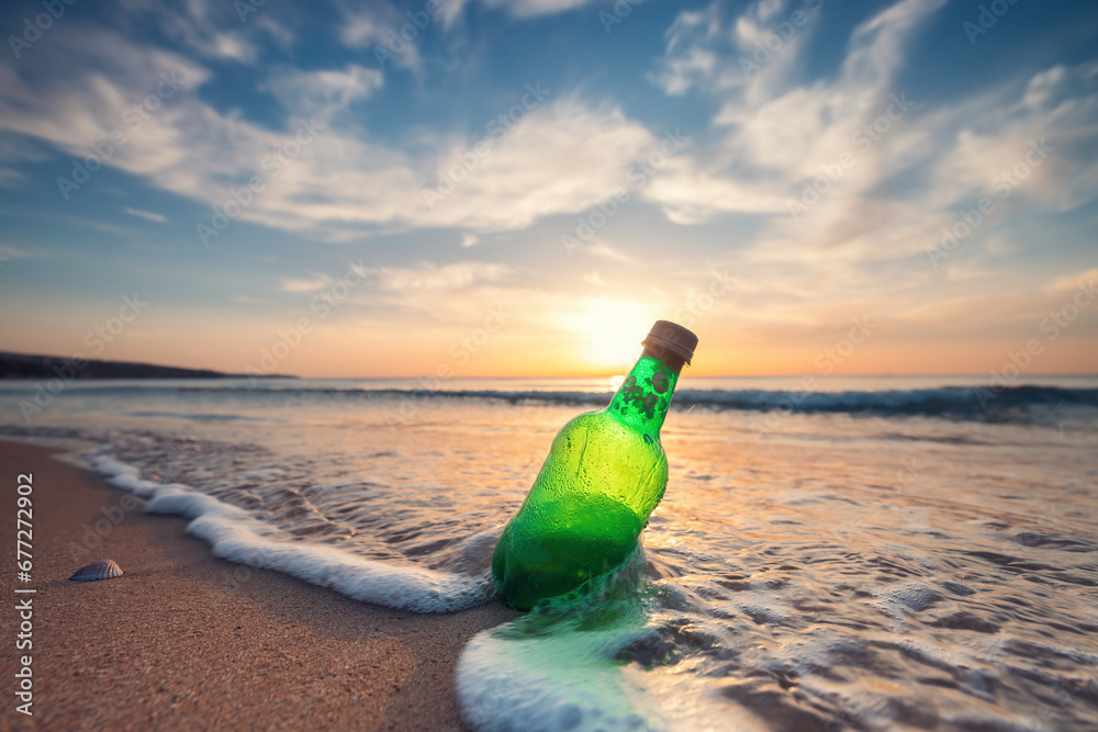 Sea sunrise and beer bottle on the beach sand and splashing waves on the shorе. Sea sunrise and beer bottle on the beach sand and splashing waves on the shorе.