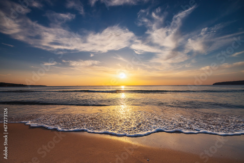 Beautiful cloudscape over the sea waves and sand, beautiful tropical beach sunrise
