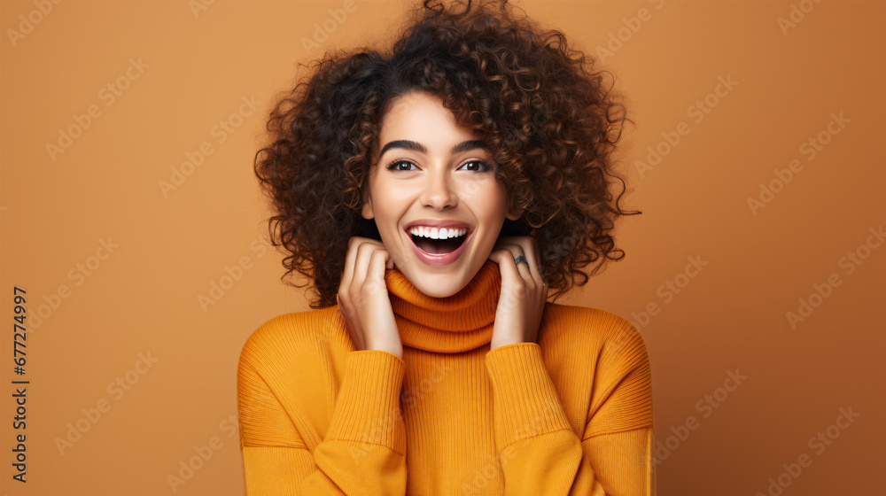 A joyful, beaming female adorned with cosmetics gleefully chuckling and signaling at the lens on an orange backdrop. A joyful, beaming female adorned with cosmetics gleefully chuckling and signaling at the lens on an orange backdrop.