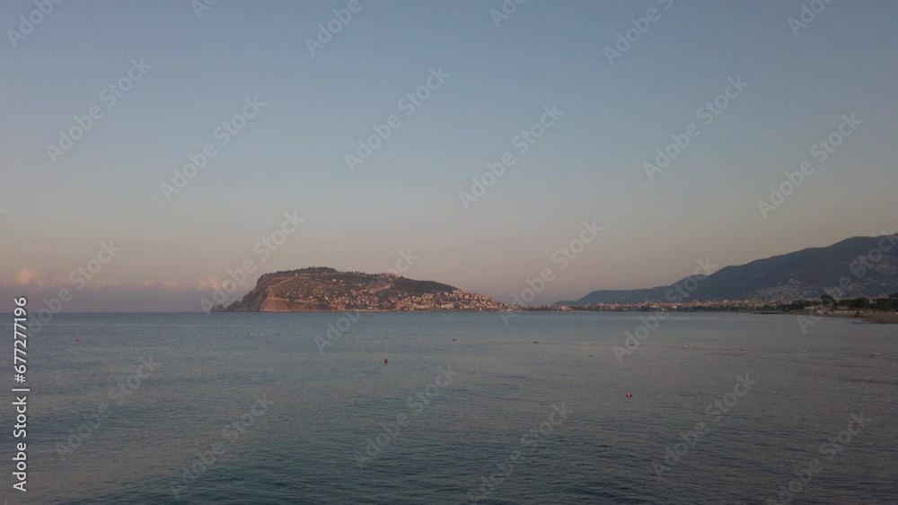 Waves of Mediterranean Sea rolling to the sandy Turkish beach in Alanya city. Travel concept Waves of Mediterranean Sea rolling to the sandy Turkish beach in Alanya city. Travel concept