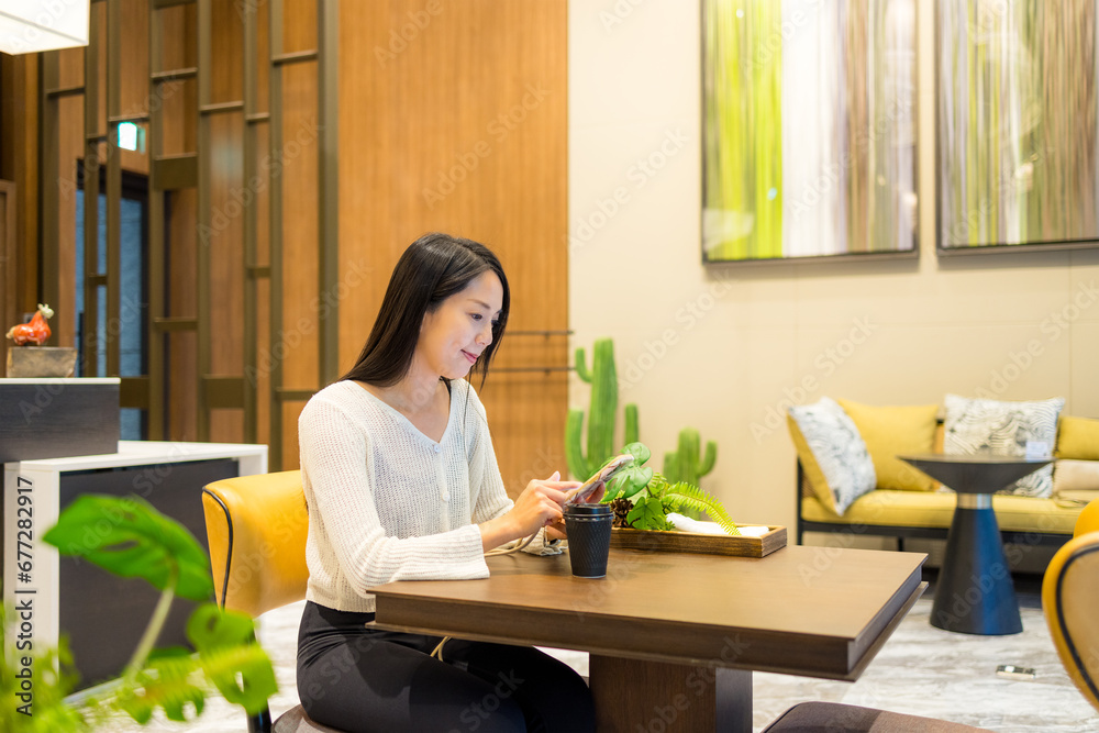 Woman use of smart phone in coffee shop Woman use of smart phone in coffee shop