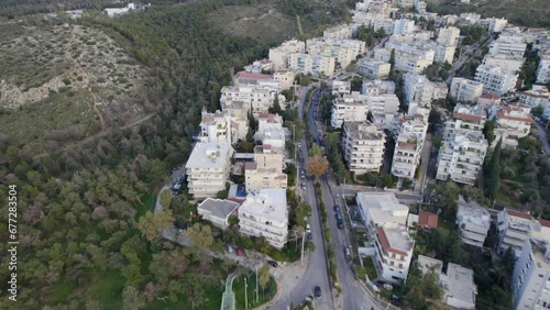 Aerial of the big Vyronas town in Greece surrounded by the mountains during the daytime photo