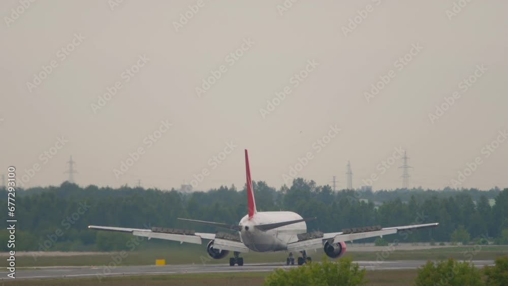 Airplane landing at the airport. Aircraft on the runway. Spoilers up Airplane landing at the airport. Aircraft on the runway. Spoilers up