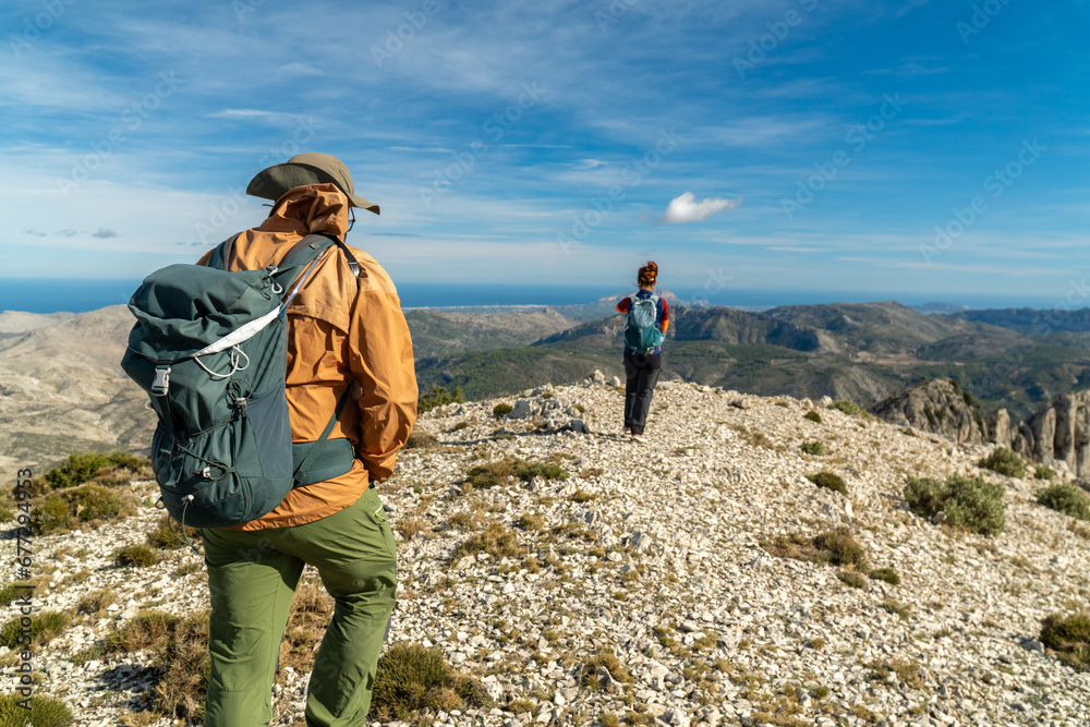 Two mountaineers walking towards the top of the mountain Two mountaineers walking towards the top of the mountain